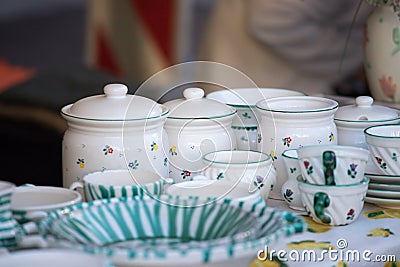 Flea market: Dishes and dinnerware in the foreground, people in the blurry background Stock Photo