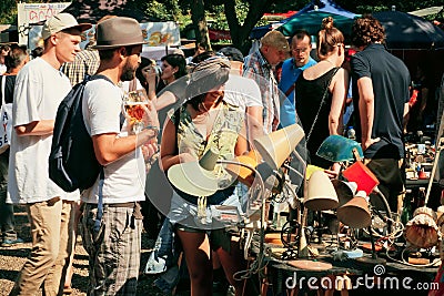 Flea market with people choosing vintage furniture Editorial Stock Photo