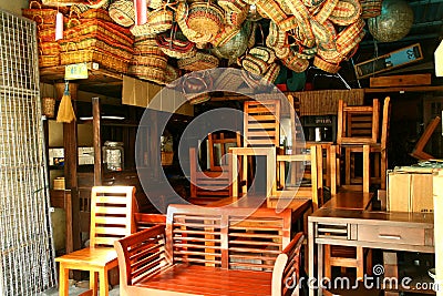 Flea market store near Dapitan Arcade in Manila, Philippines selling wooden furniture. Editorial Stock Photo