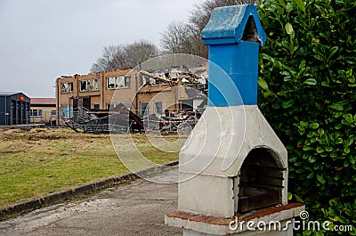 Flensburg Fahrensodde Burning Fire Airplane hanger. View of an outdoor blue and white chimney in foreground Stock Photo