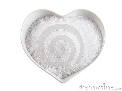Fleur de sel in a heart-shaped bowl on white Stock Photo