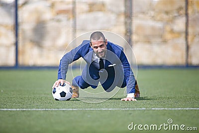 Flexed businessman leaning on a ball Stock Photo