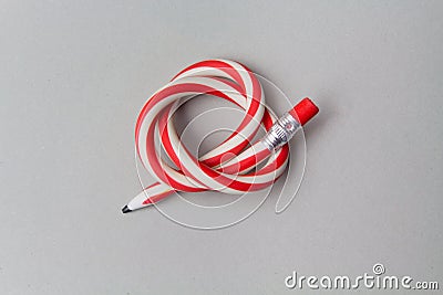 Flexible pencil on a grey background. Bent pencils two-color Stock Photo