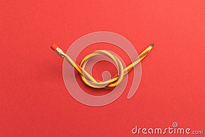 Flexible pencil . Isolated red background Stock Photo