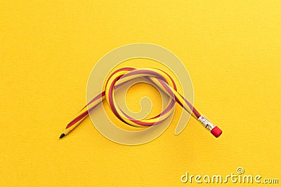 Flexible pencil . Isolated on yellow background Stock Photo