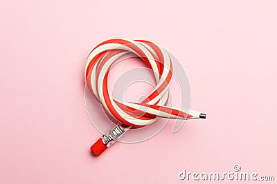 Flexible pencil on a pink background. Bent pencils two-color Stock Photo