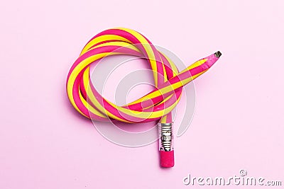 Flexible pencil on a pink background. Bent pencils two-color Stock Photo