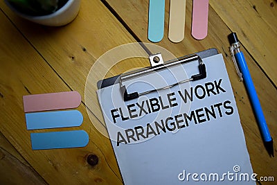Flexible Work Arrangements write on a paperwork isolated on wooden background Stock Photo