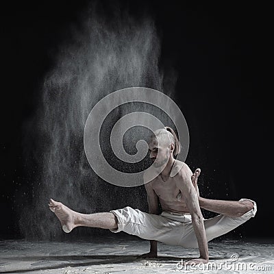 Flexible yoga man doing hand balance asana brahmachariasana. Stock Photo