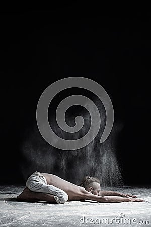 Flexible yoga man practices yoga asana balasana child`s pose. Stock Photo