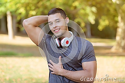 Flexing muscles posing runner young latin man running jogging sports training fitness workout Stock Photo