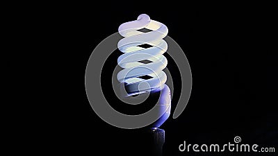 Flickering Fluorescent Light Bulb in Dark Room Against Black Background