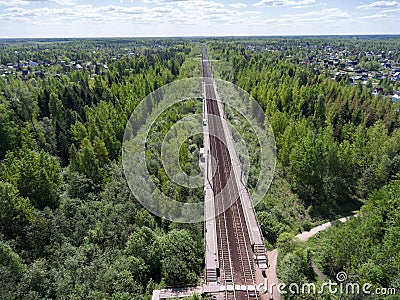 Flight above country railroad and rural platform station between villages, summer season Stock Photo