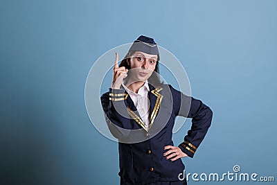 Flight attendant pointing up with index finger Stock Photo