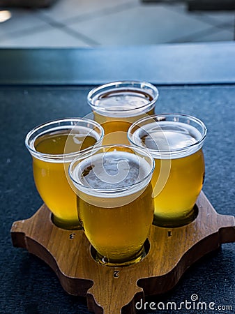 A flight of beers on a wooden paddle Stock Photo