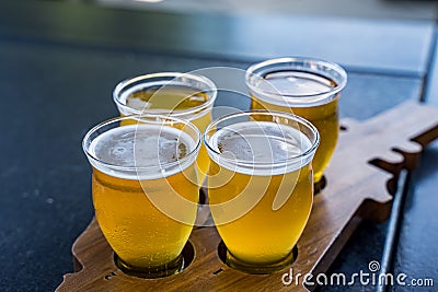 A flight of beers on a wooden paddle Stock Photo