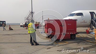 Flight Engineer and Aircraft maintenance staff conducting routine checking of the airplane. Editorial Stock Photo