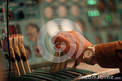 Flight engineer holds handle of throttle Stock Photo