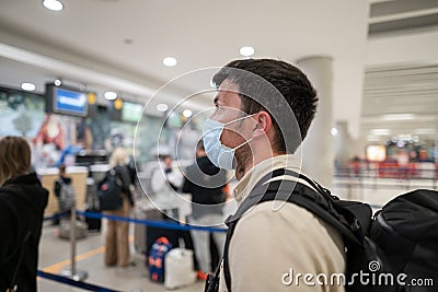 Flight rules during Covid-19 pandemic only in protective face mask. New normal concept. Masked man with phone in hand Stock Photo