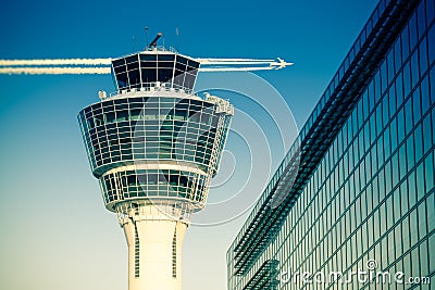 Flights management air control tower passenger terminal and flying plane Stock Photo