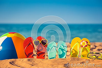 Flip-flops, beach ball and snorkel on the sand Stock Photo