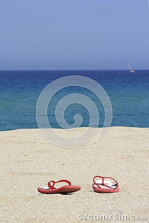 Flip flops on empty sandy beac Stock Photo