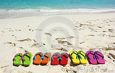 Flipflops on a sandy ocean beach. Stock Photo