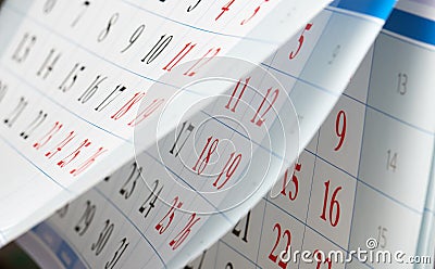 Flipping of calendar sheets with black and red numbers Stock Photo