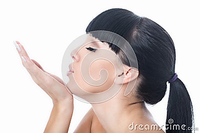 Flirtatious Romantic Beautiful Young Woman Blowing a Kiss Stock Photo