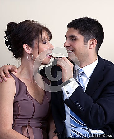 Flirting Formal Couple with Chocolate Stock Photo