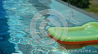 Floater on blue water in swimming pool with sun light in summer vacation holiday concept with copy space Stock Photo