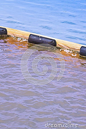 Floating anti-pollution barrier made with modular plastic elements - image with copy space Stock Photo