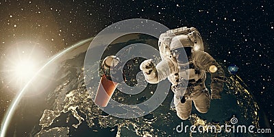 Floating astronaut and coffee mug at sunrise. Coffee break and breakfast concept. 3D and photo compositing, elements from NASA Stock Photo