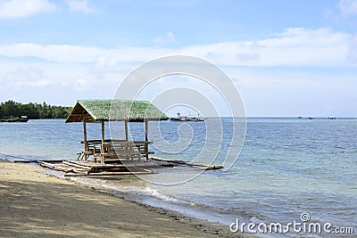 Floating beach bamboo and palm cottage parasol on white sand coast Stock Photo