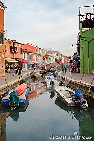 Floating boats on the canal between small colored houses Editorial Stock Photo