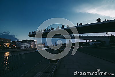 Floating bridge with people above Moscow river in the park Zaryadye near Red Square. Bottom view of the Hovering modern bridge in Stock Photo