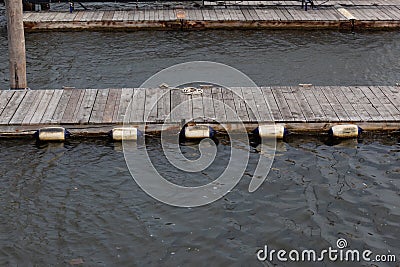 Floating docks with bumpers, weathered wood and water copy space Stock Photo