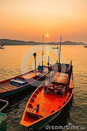 Floating fishing boats aground at the harbor in the sea sunriset time Stock Photo