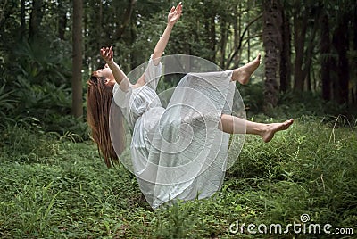 Floating Girl in Forest Stock Photo