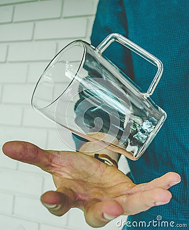 Floating glass over hand Stock Photo