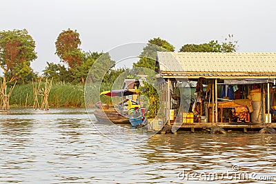 Floating houses and boats on Tonle Sap River in Cambodia Stock Photo