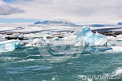 Floating icebergs and view to the glacier, ice lagoon Jokulsarlon, Iceland Stock Photo