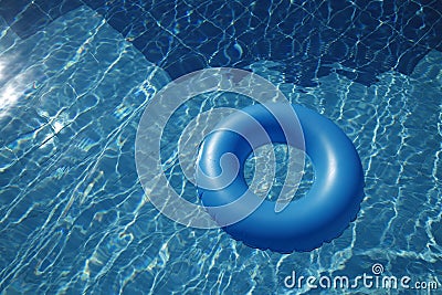 Floating inner tube in a pool Stock Photo