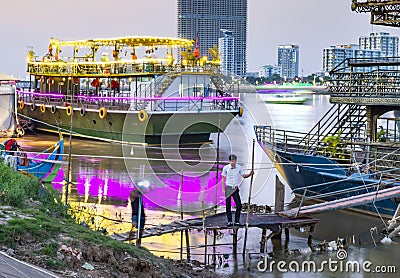 Floating nightclubs and pleasure boats,moored alongside Phnom Penh's riverbank Editorial Stock Photo