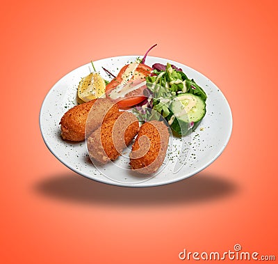 Floating White plate with three Shrimps croquettes ans salad Stock Photo