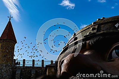 Flocks of migratory birds, high in the sky. They fly overhead against the blue sky. Black silhouettes with wings in large Stock Photo