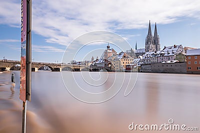 Flood of the river Danube in winter 2021 in Regensburg with view of the cathedral the old town and flooded promenade and the stone Editorial Stock Photo