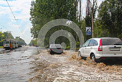 Flood. Road and cars under water. Heavy rain and downpour flooded city streets with water. strong deluge. Natural anomaly. Bad Editorial Stock Photo