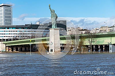 Flood of the Seine river in Paris near Statue of Liberty replica Editorial Stock Photo