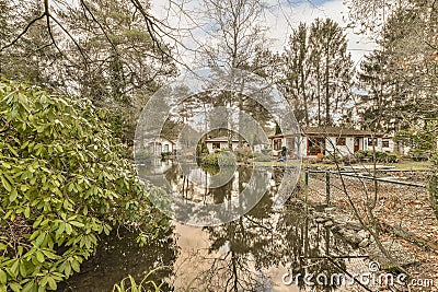 a view of a pond with houses in the background Stock Photo